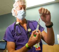 Anesthesiologist holding syringe.